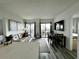 Living room with sofa, dining area, and balcony view at 6165 Carrier Dr # 3802, Orlando, FL 32819