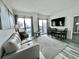 Bright living room featuring a comfortable sofa and dining area at 6165 Carrier Dr # 3802, Orlando, FL 32819