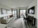Open living room and dining area with a modern aesthetic at 6165 Carrier Dr # 3802, Orlando, FL 32819