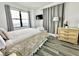 Comfortable bedroom with a bed, dresser, and floor-to-ceiling window at 6165 Carrier Dr # 3802, Orlando, FL 32819