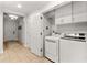 Bright laundry room with washer, dryer, and cabinets at 1350 Centre Court Ridge # 103, Reunion, FL 34747