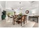 Open dining room with large glass table and access to living room at 1350 Centre Court Ridge # 103, Reunion, FL 34747