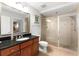 Bathroom with a walk-in shower and granite vanity at 1350 Centre Court Ridge # 103, Reunion, FL 34747