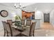 Bright dining area features a glass-top table and six chairs at 1350 Centre Court Ridge # 103, Reunion, FL 34747