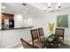 Elegant dining room with glass-top table and modern chandelier at 1350 Centre Court Ridge # 103, Reunion, FL 34747