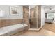 Primary bathroom with soaking tub and walk-in shower at 1350 Centre Court Ridge # 103, Reunion, FL 34747