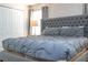 Spacious bedroom with large bed and gray accents at 1568 Plunker Dr, Davenport, FL 33896