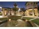 Elegant community courtyard with a central fountain at night at 1568 Plunker Dr, Davenport, FL 33896