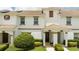 Two-story townhome with a landscaped front yard at 1568 Plunker Dr, Davenport, FL 33896