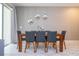 Modern dining room with a wood table and gray chairs at 1568 Plunker Dr, Davenport, FL 33896