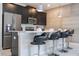Modern kitchen with dark cabinets, stainless steel appliances, and breakfast bar at 1568 Plunker Dr, Davenport, FL 33896