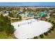 Aerial view of community with a resort-style pool and sand volleyball court at 1568 Plunker Dr, Davenport, FL 33896