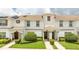 Two-story townhome with a landscaped front yard at 1568 Plunker Dr, Davenport, FL 33896