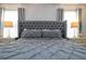 Main bedroom with plush bed, gray decor, and ample natural light at 1568 Plunker Dr, Davenport, FL 33896