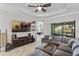Relaxing Gathering room boasts a large sectional sofa, big screen TV, and access to the backyard at 32619 View Haven Ln, Sorrento, FL 32776