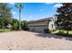 Two-car garage with paver driveway and lush landscaping at 32619 View Haven Ln, Sorrento, FL 32776