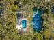 Aerial view of community pool and tennis court surrounded by trees at 4407 Sea Mist Ct # 267, New Smyrna Beach, FL 32169