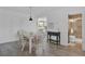 Beachy dining room with white table and chairs, adjacent to kitchen and bath at 4407 Sea Mist Ct # 267, New Smyrna Beach, FL 32169
