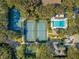 Community tennis courts, swimming pool, and surrounding lush greenery at 4407 Sea Mist Ct # 267, New Smyrna Beach, FL 32169