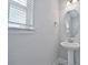 Small powder room with pedestal sink and octagon mirror at 7424 Bent Tree Loop, St Cloud, FL 34771