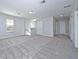 Spacious loft area with grey carpet and multiple doors at 7424 Bent Tree Loop, St Cloud, FL 34771
