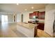 Open kitchen with island and stainless steel appliances at 16253 Pebble Bluff Loop, Winter Garden, FL 34787