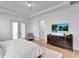 Bright and airy main bedroom with a comfortable bed, large TV, and private balcony at 7540 Estuary Lake Loop, Celebration, FL 34747