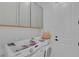 Convenient laundry room with washer, dryer, and overhead cabinets at 7540 Estuary Lake Loop, Celebration, FL 34747