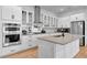 Modern kitchen with white cabinets, large island, and stainless steel appliances at 7540 Estuary Lake Loop, Celebration, FL 34747