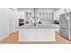 Large kitchen island with grey countertop and white cabinetry at 7540 Estuary Lake Loop, Celebration, FL 34747