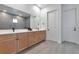 Modern bathroom with double vanity, large mirror, and walk-in shower at 7540 Estuary Lake Loop, Celebration, FL 34747