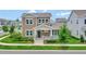 Two-story craftsman style home with front porch and landscaping at 7540 Estuary Lake Loop, Celebration, FL 34747