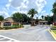 Gated entrance to Crescent Place Condominiums with palm trees and signage at 837 Grand Regency Pt # 207, Altamonte Springs, FL 32714