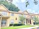 Tan two-story townhome with manicured lawn at 837 Grand Regency Pt # 207, Altamonte Springs, FL 32714