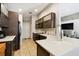 Updated kitchen featuring dark wood cabinets, quartz countertops, and a breakfast bar at 514 Troon Cir, Davenport, FL 33897