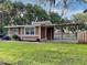 House exterior with covered patio and well-maintained lawn at 424 E Welch Rd, Apopka, FL 32712