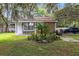 Single-story home with stone facade, landscaping, and a palm tree at 424 E Welch Rd, Apopka, FL 32712