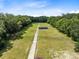Long driveway leading to a structure in a grassy field at 424 E Welch Rd, Apopka, FL 32712
