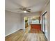 Open living room with wood-look floors and kitchen view at 424 E Welch Rd, Apopka, FL 32712