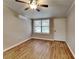 Light and airy living room with wood-look floors and window at 424 E Welch Rd, Apopka, FL 32712
