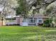 House exterior showcasing a lovely lawn and covered patio at 424 E Welch Rd, Apopka, FL 32712