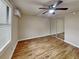 Well-lit bedroom featuring wood-look floors and large window at 424 E Welch Rd, Apopka, FL 32712