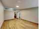 Bright living room with wood-look floors and kitchen access at 424 E Welch Rd, Apopka, FL 32712