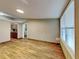 Living room with wood flooring and large window with blinds at 424 E Welch Rd, Apopka, FL 32712