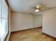 Bright bedroom featuring wood-look floors and window with blinds at 424 E Welch Rd, Apopka, FL 32712