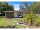 Single-story home with stone facade, landscaping, and a palm tree at 424 E Welch Rd, Apopka, FL 32712