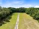 Long driveway through grassy field, aerial view at 424 E Welch Rd, Apopka, FL 32712