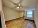 Well-lit bedroom with mirrored closet doors and ceiling fan at 424 E Welch Rd, Apopka, FL 32712