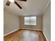 Simple bedroom with wood-look floors and large window at 424 E Welch Rd, Apopka, FL 32712