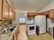 Modern kitchen with wood cabinets and stainless steel appliances at 424 E Welch Rd, Apopka, FL 32712